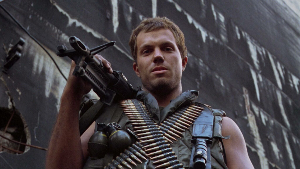 Adam Baldwin as Animal Mother holding machine gun with ammo belt intense Full Metal Jacket scene Wallpaper