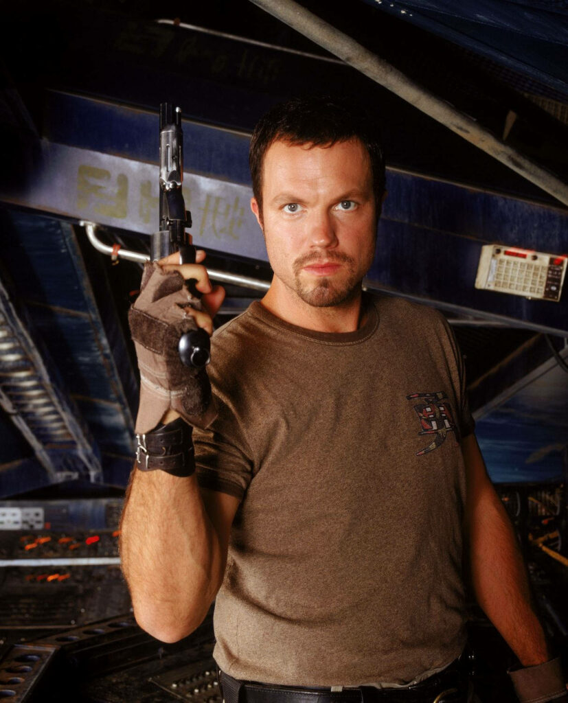Adam Baldwin as Jayne Cobb holding gun tough rugged sci-fi Firefly wallpaper background
