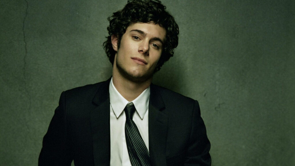 Adam Brody confident in sharp suit against textured gray background stylish wallpaper