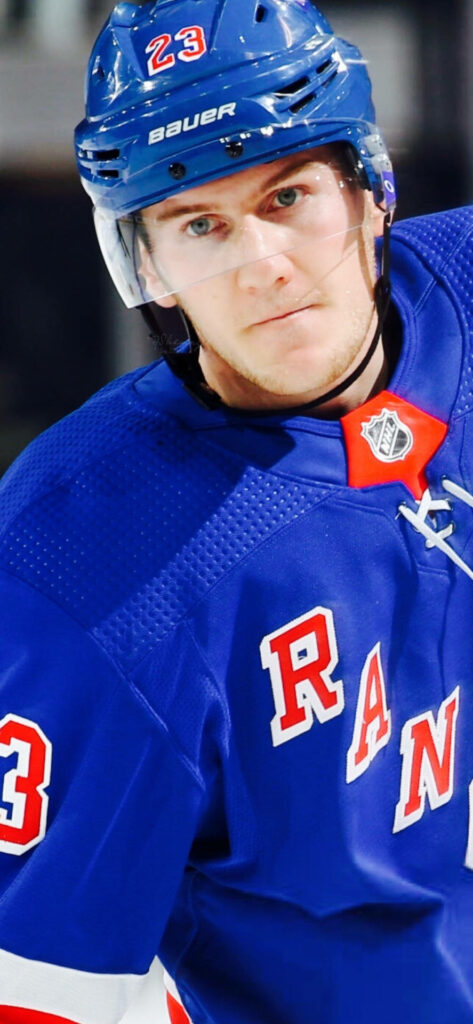 Adam Fox in blue New York Rangers uniform intensely focused during dynamic hockey wallpaper