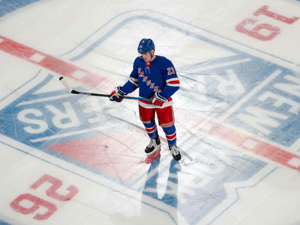Adam Fox New York Rangers poised on ice at Madison Square Garden dynamic hockey wallpaper background