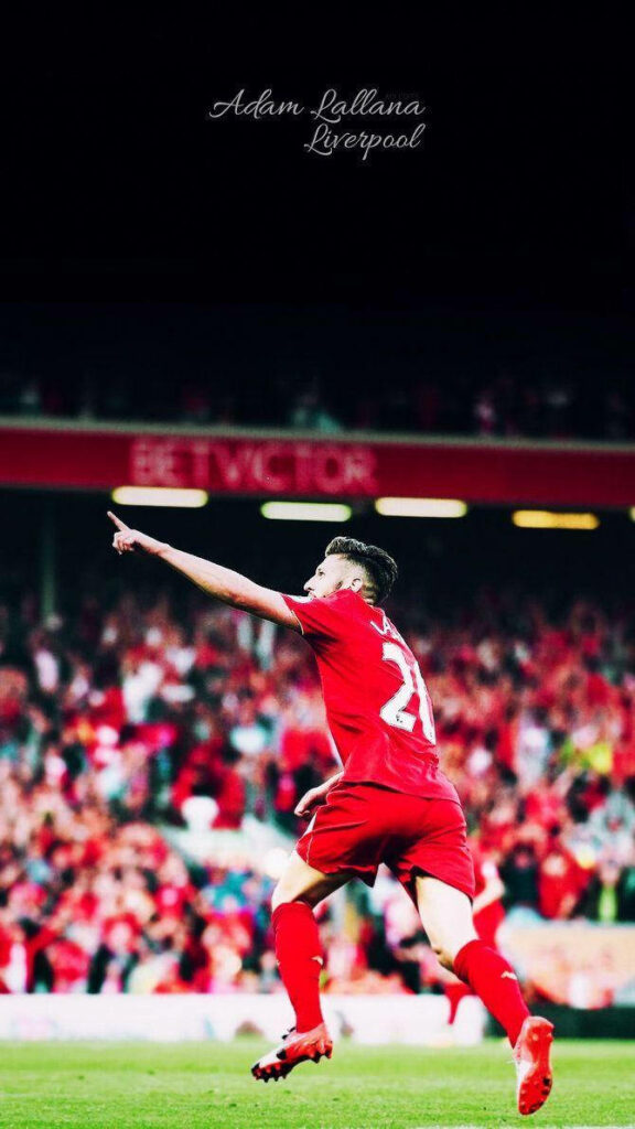 Adam Lallana celebrates on Liverpool pitch pointing to fans in joyful match moment wallpaper background