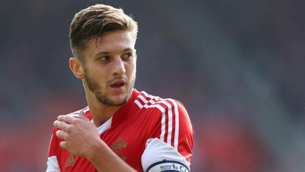 Adam Lallana focused sideways in red white football jersey wallpaper background image