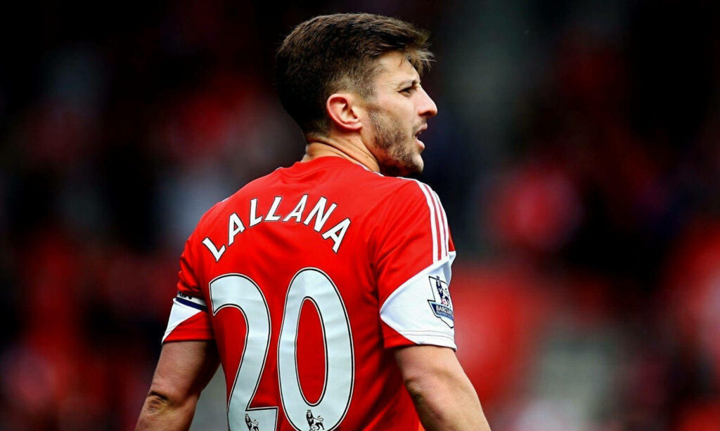 Adam Lallana wearing number 20 jersey during intense football match with vibrant stadium background Wallpaper