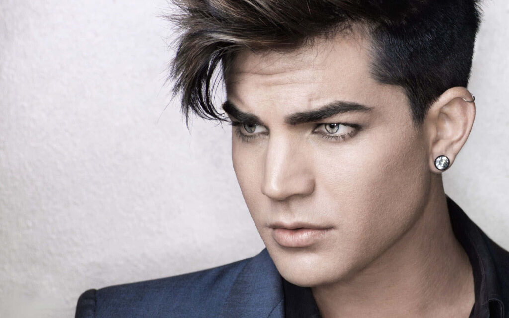 Close-up portrait of Adam Lambert showcasing sharp features bold hairstyle and signature style Wallpaper