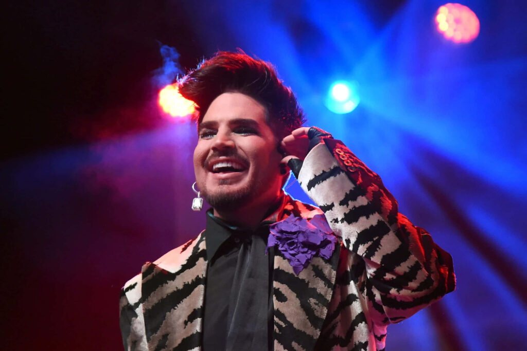 Adam Lambert energetic stage performance vibrant lighting dynamic wallpaper background