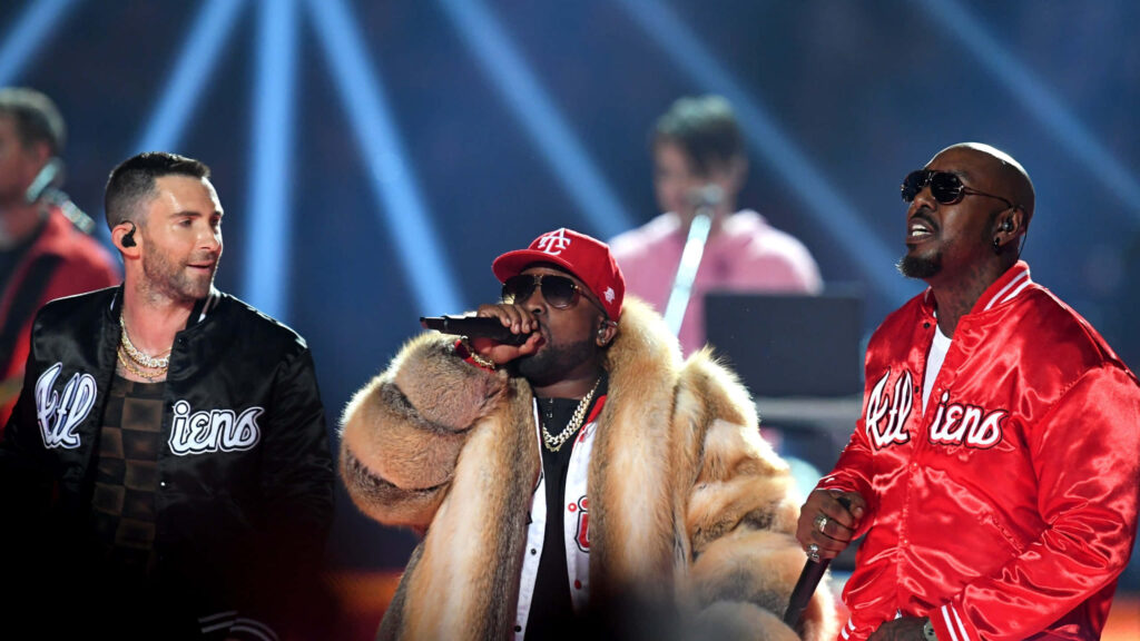 Adam Levine Big Boi and Sleepy Brown performing live on colorful vibrant concert stage background Wallpaper