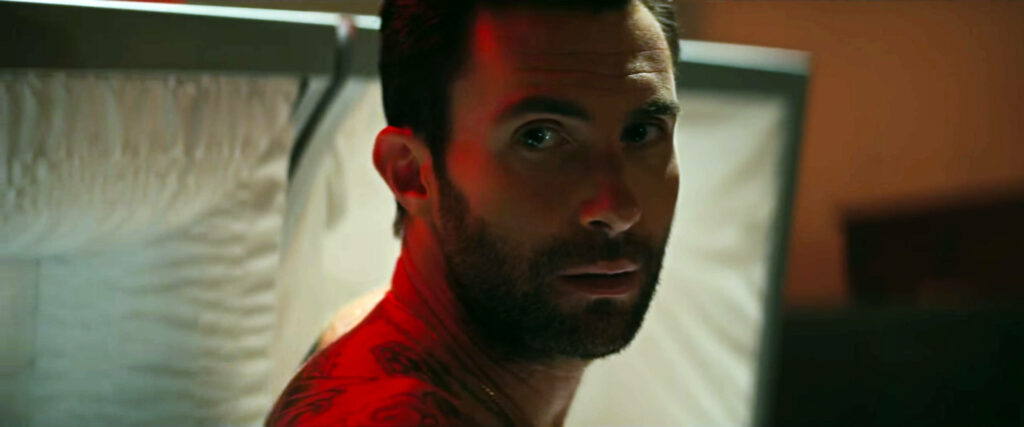 Adam Levine intense stare tattooed shoulder dramatic lighting captivating wallpaper background