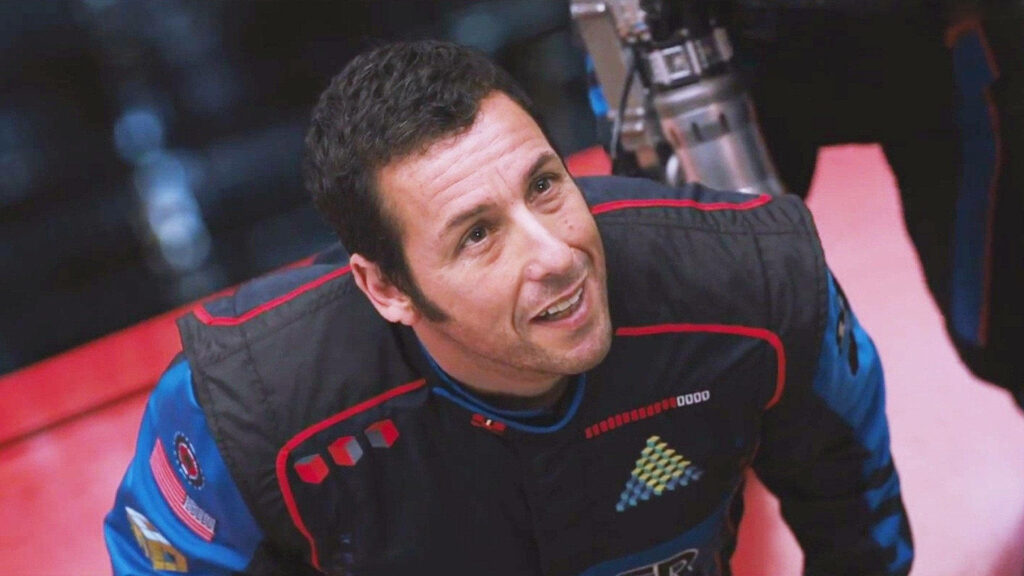 Adam Sandler in futuristic racing suit looking hopeful inspiring energetic wallpaper background