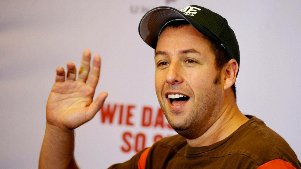 Adam Sandler smiling and waving warmly cheerful friendly wallpaper background image