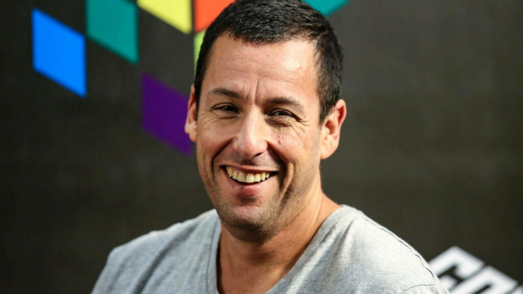 Adam Sandler warm smile vibrant wallpaper friendly approachable personality background