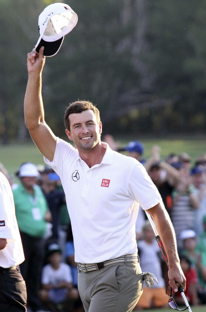 Adam Scott celebrating victory on golf course raising hat with smiling crowd background wallpaper