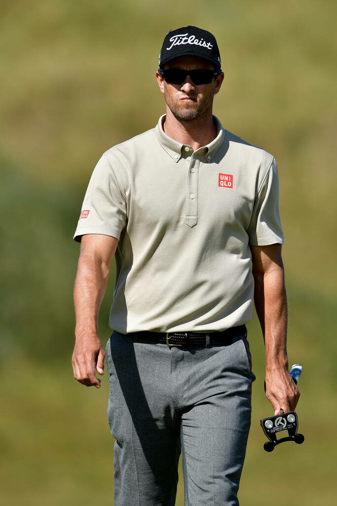 Adam Scott walking confidently on sunny golf course wearing light polo sunglasses and cap Wallpaper