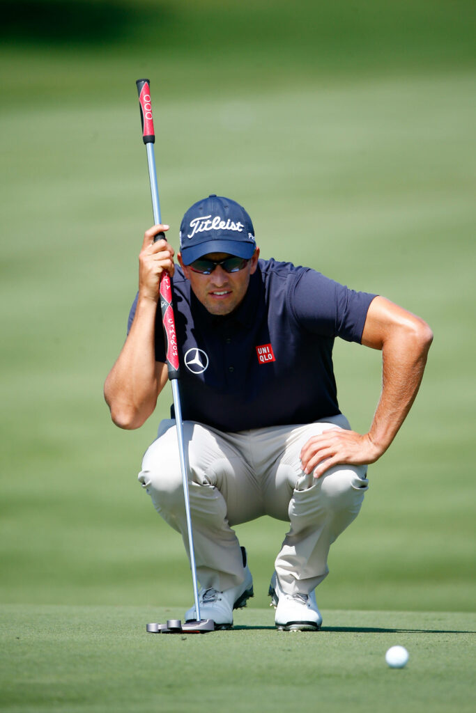 Adam Scott focused golfing on green preparing putt showing determination and concentration Wallpaper