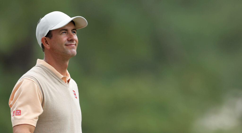 Adam Scott hopeful outdoors wearing light polo cap blurred green background wallpaper