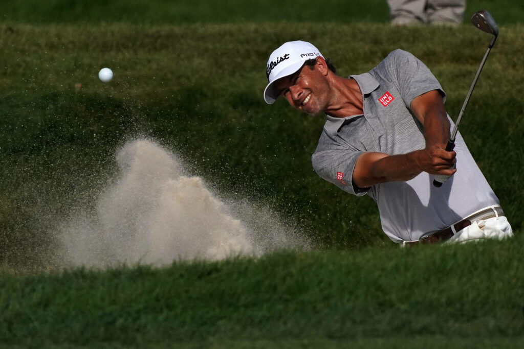 Adam Scott hitting a powerful golf shot from sand bunker showing focus in professional golf Wallpaper