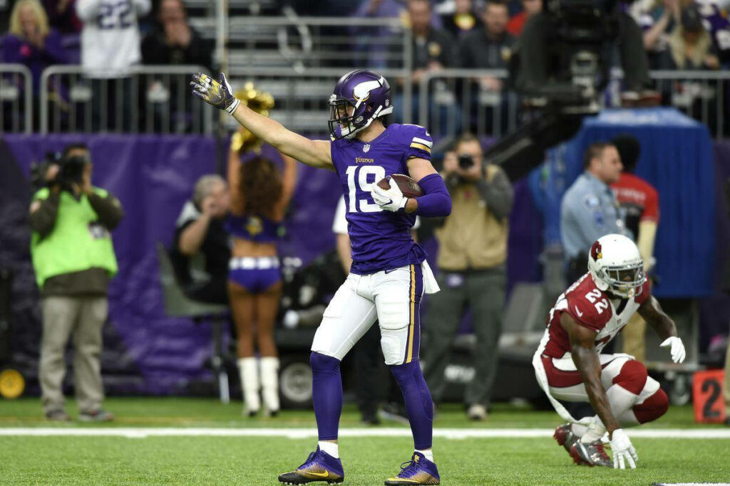 Adam Thielen in Action: Intense Evening Football Match Wallpaper