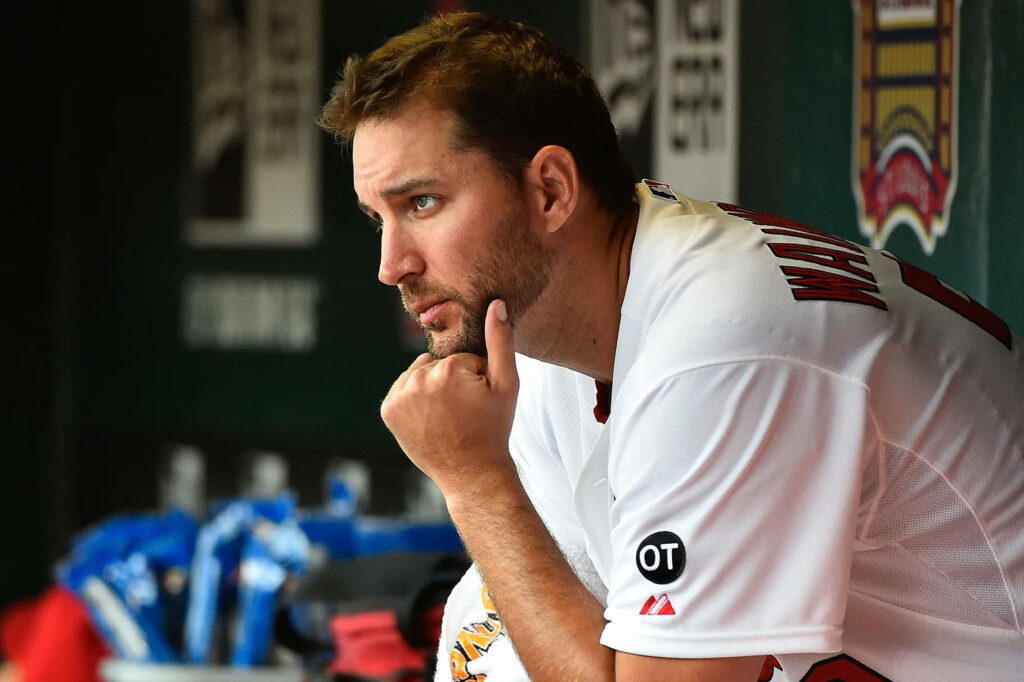 Adam Wainwright in St Louis Cardinals uniform thoughtful pose in dugout reflective wallpaper