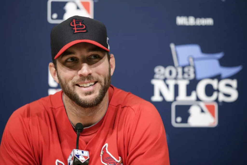 Adam Wainwright smiling in St. Louis Cardinals uniform at 2013 NLCS press conference wallpaper