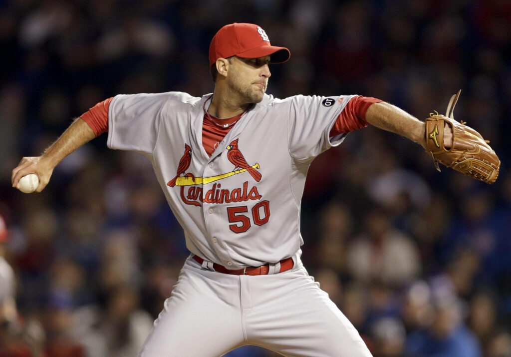 Adam Wainwright pitching in St Louis Cardinals uniform on baseball field wallpaper background