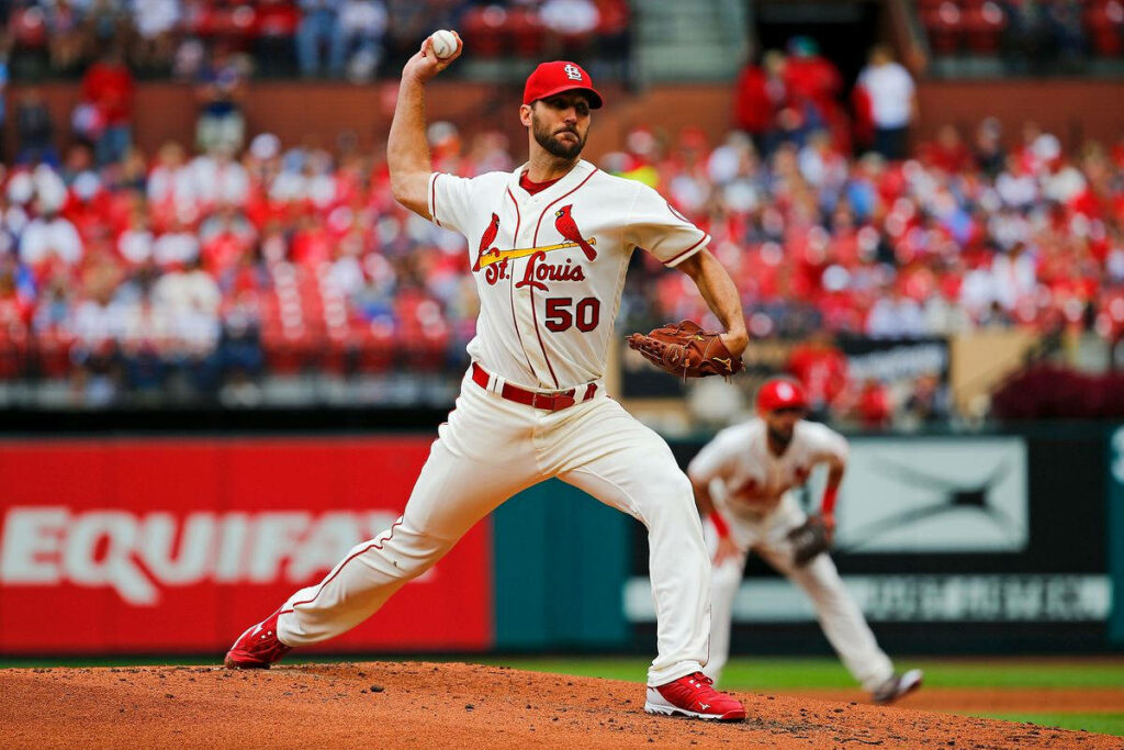 Adam Wainwright pitching in St Louis Cardinals uniform on mound with focused crowd background Wallpaper