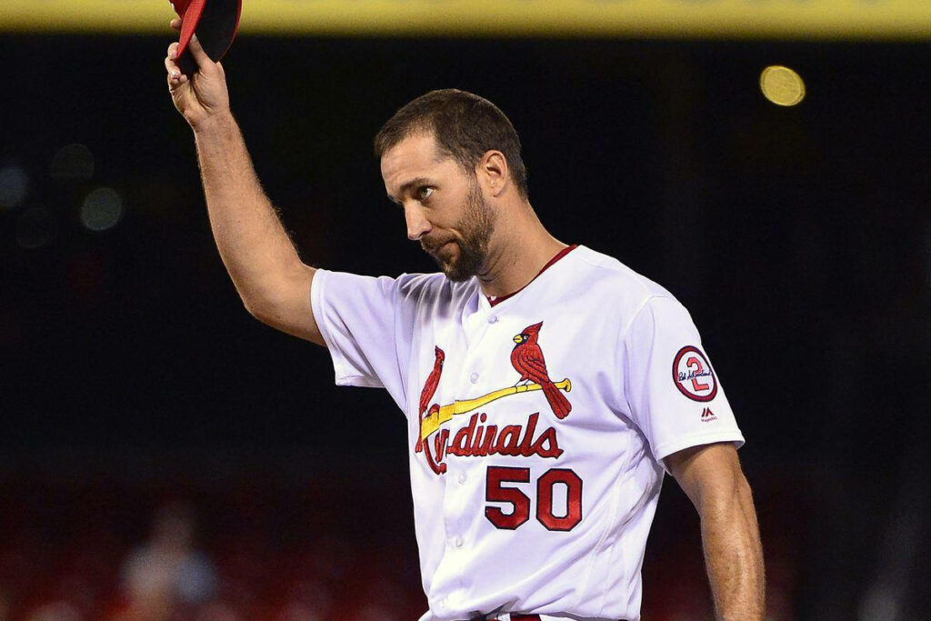 Adam Wainwright in St Louis Cardinals uniform saluting crowd with cap tribute moment wallpaper