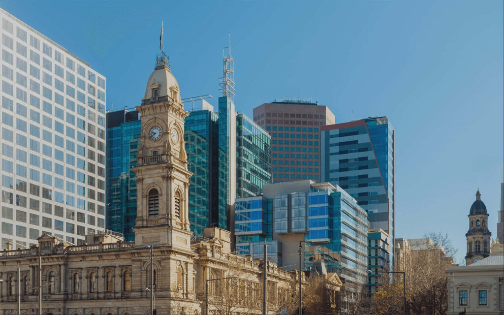 Adelaide cityscape with historic buildings and modern glass skyscrapers under clear blue sky wallpaper