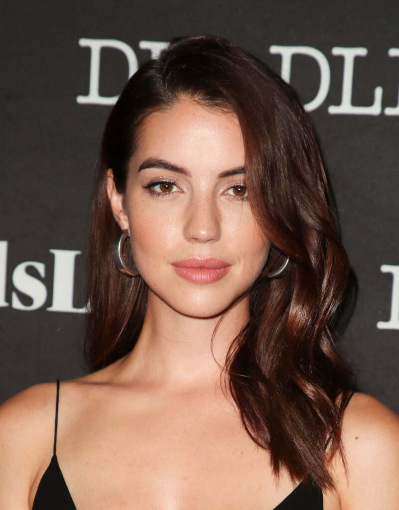 Adelaide Kane elegant portrait at event with branded wallpaper background for sophisticated look