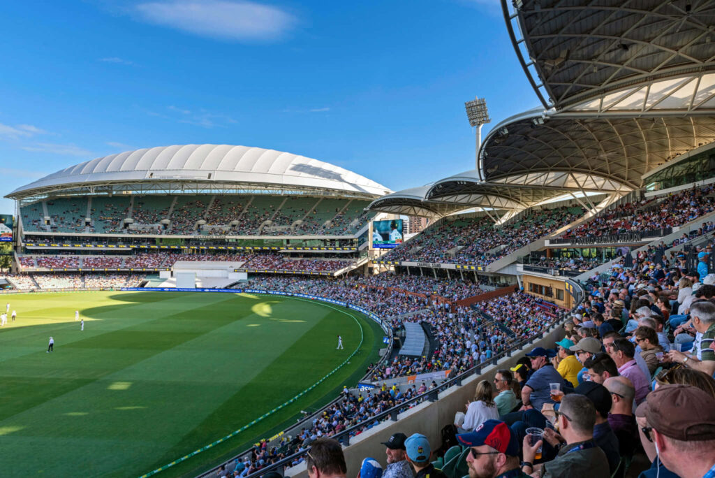 Adelaide Oval packed stadium cricket match day blue sky fans cheering vibrant wallpaper background