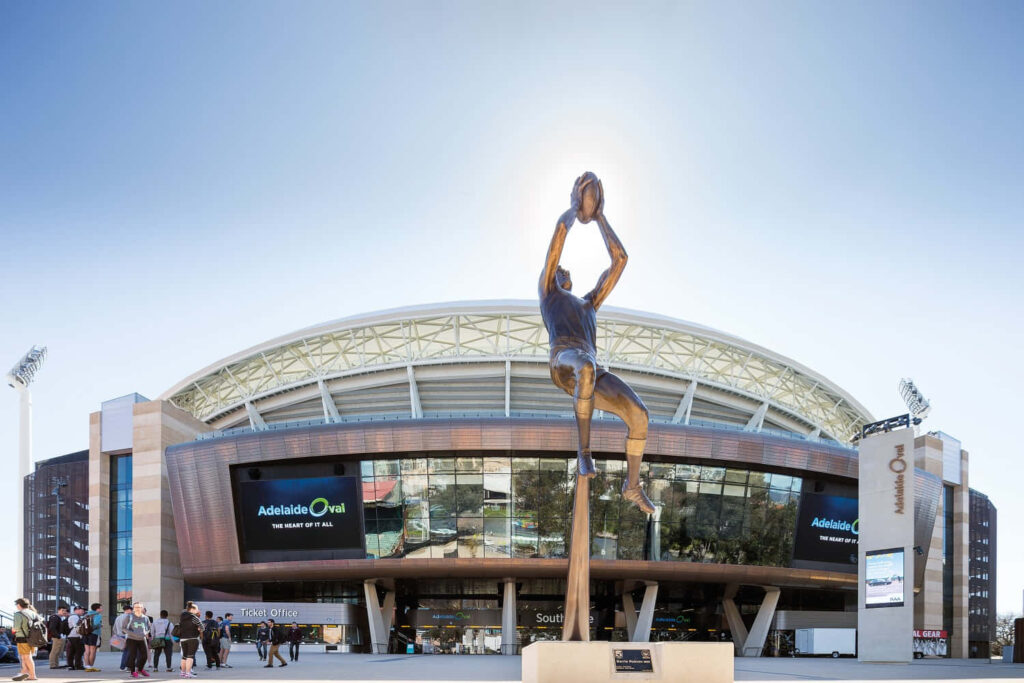 Adelaide Oval entrance with dynamic sports player statue vibrant iconic Australian stadium view Wallpaper