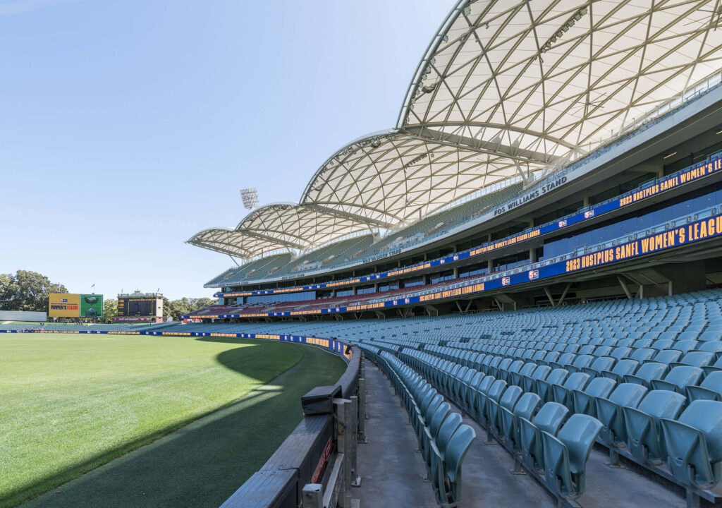 Adelaide Oval Stadium panoramic view with curved roof and vibrant green playing field wallpaper