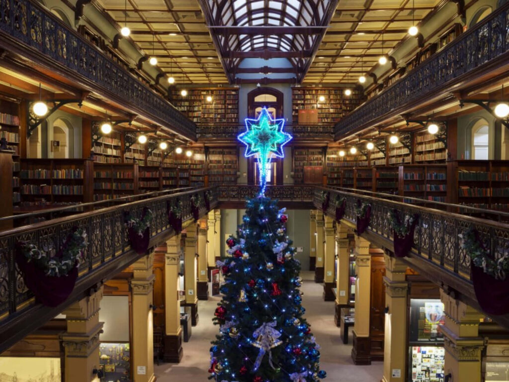 Adelaide State Library interior Christmas decor grand tree blue ornaments glowing star wallpaper