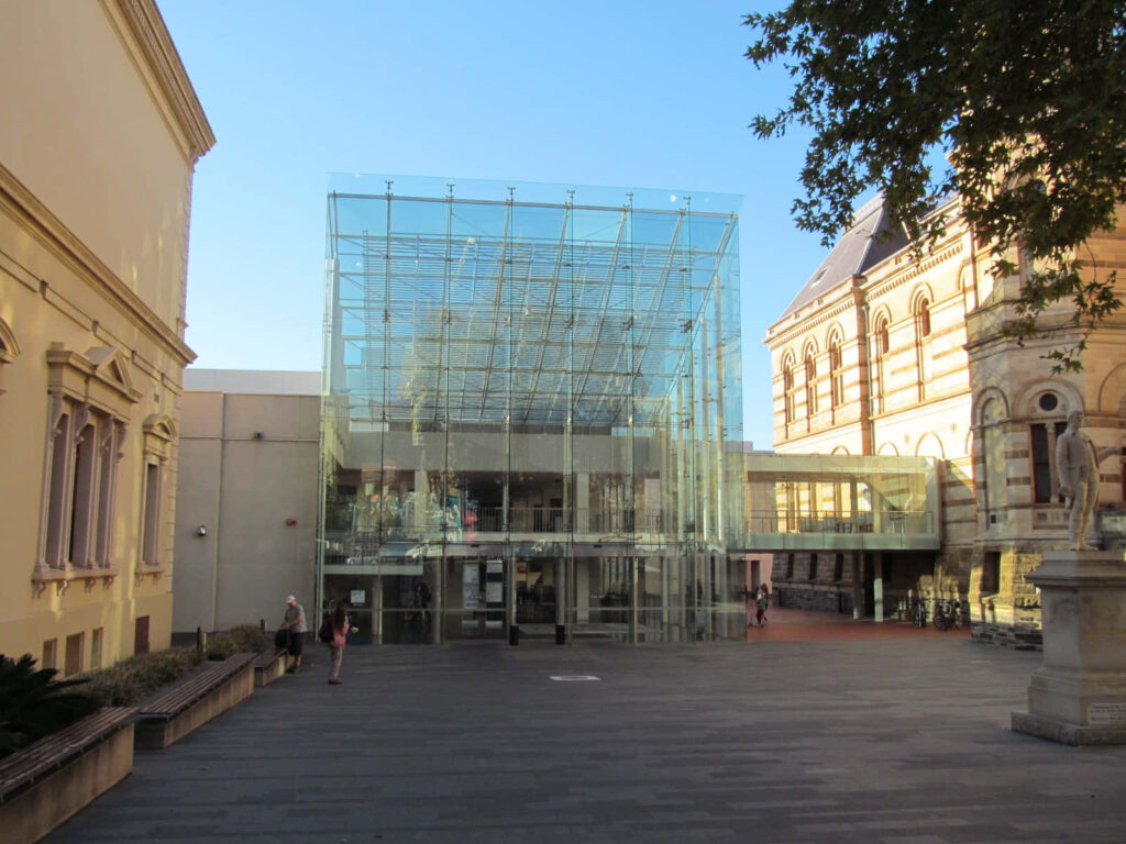 Modern glass entrance of Adelaide State Library blending contemporary and historic architecture Wallpaper