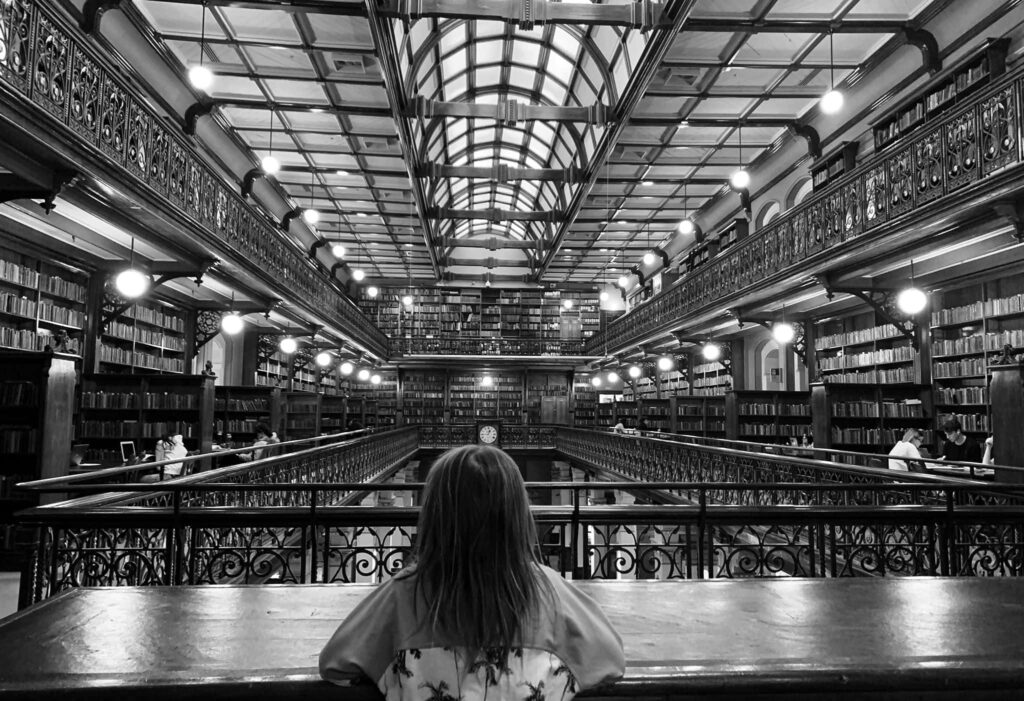 Black and white Adelaide State Library interior with balconies bookshelves and glass ceiling view Wallpaper