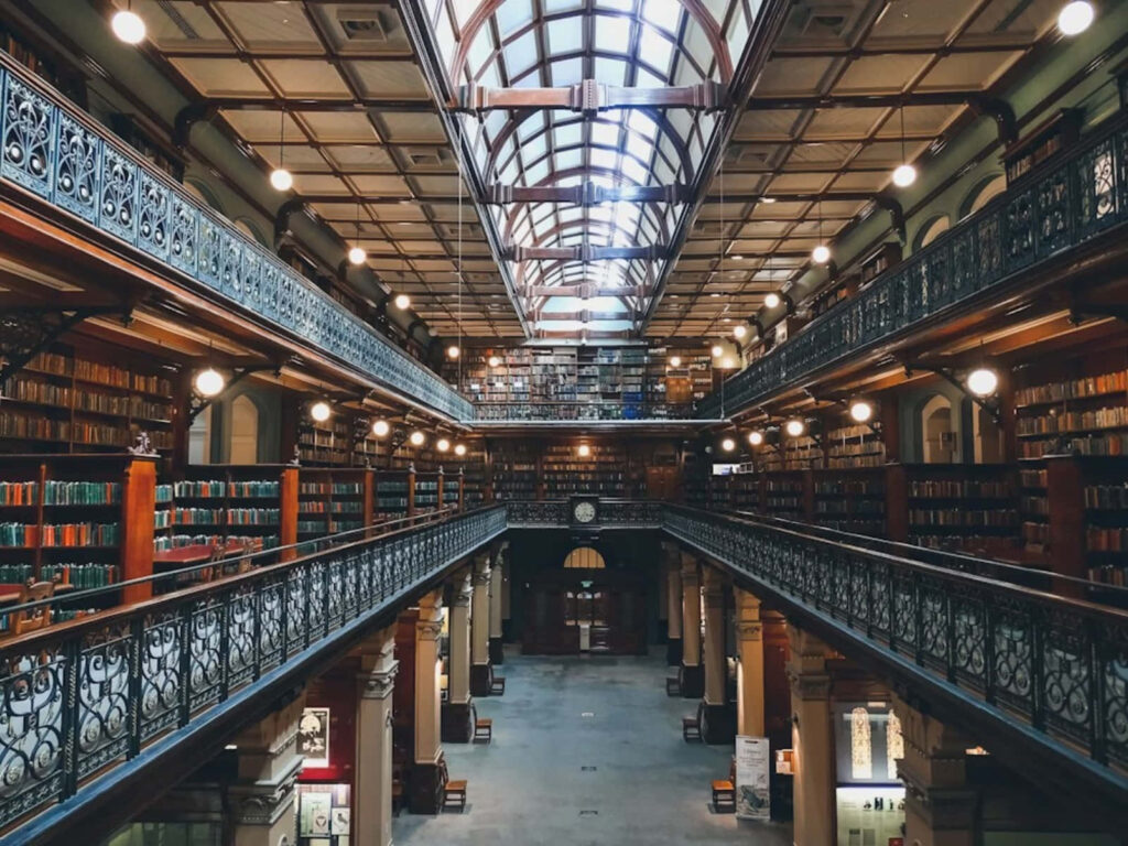 Adelaide State Library interior with ornate iron balconies historic shelves and arched ceilings Wallpaper