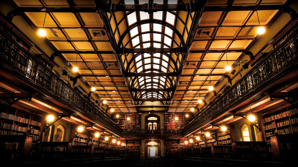Stunning Adelaide State Library interior with grand archways ornate balconies and warm lighting Wallpaper