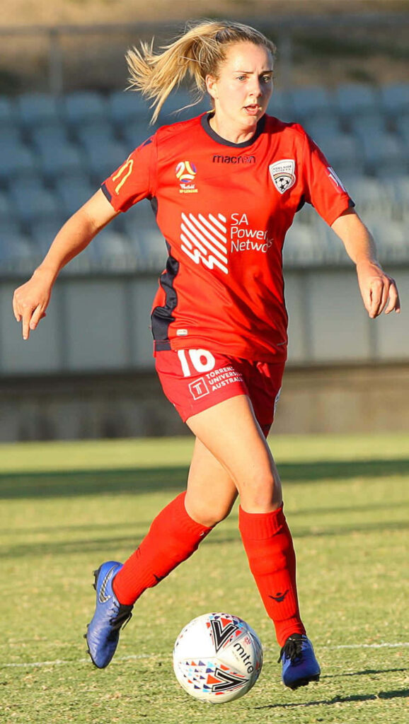 Adelaide United soccer player controlling ball in intense match showcasing team energy wallpaper