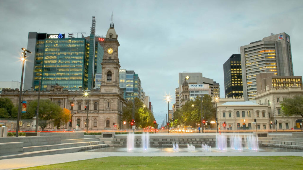 Adelaide Victoria Square dusk clock tower modern buildings softly lit fountains urban wallpaper