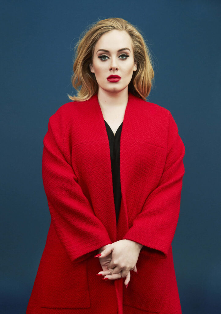 Adele's Elegant Red Coat: Confident Wallpaper Against Blue Background