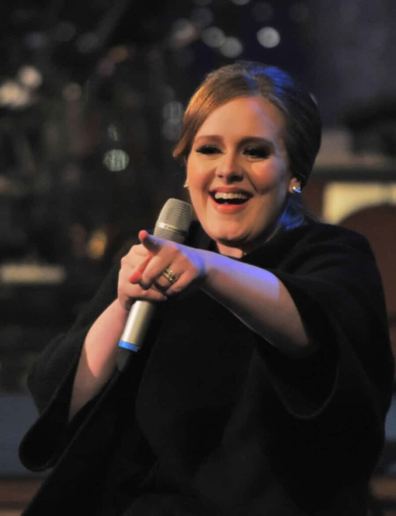 Elegant Adele Wallpaper: Iconic Singer Smiling with Microphone
