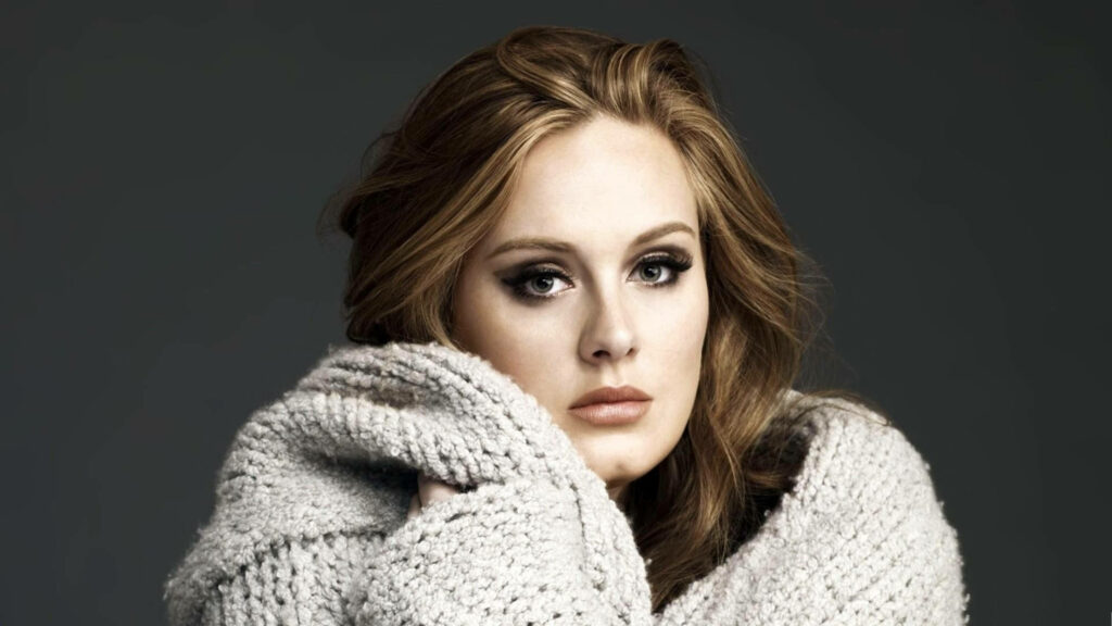 Adele in Cozy Sweater: Elegant Wallpaper Background