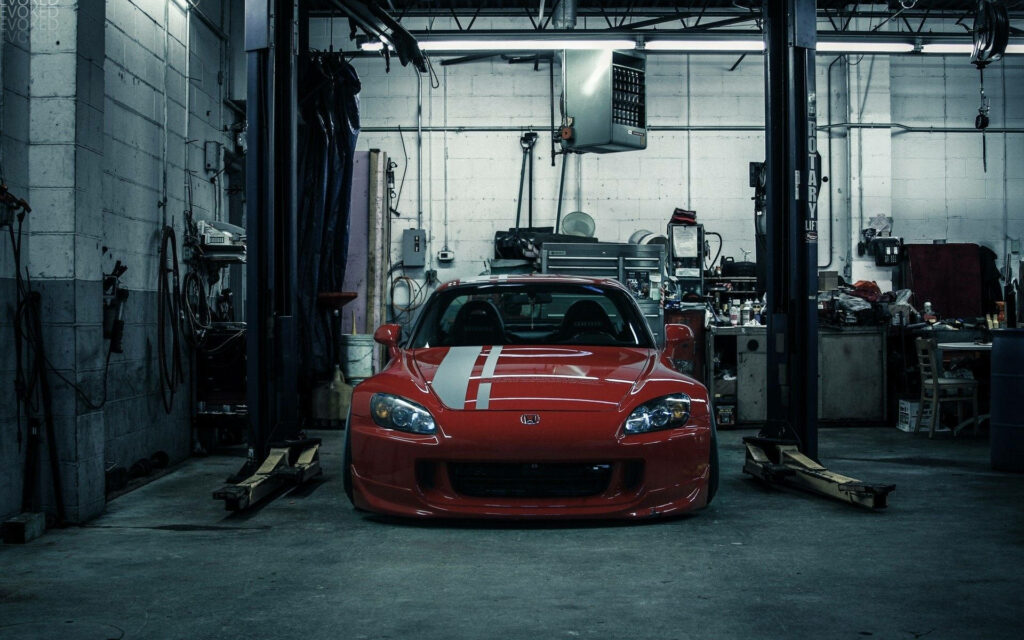 Revved Up: Showcasing a Stunning JDM Honda S2000 in a Custom Red Finish within a Stylish Tuning Garage Wallpaper