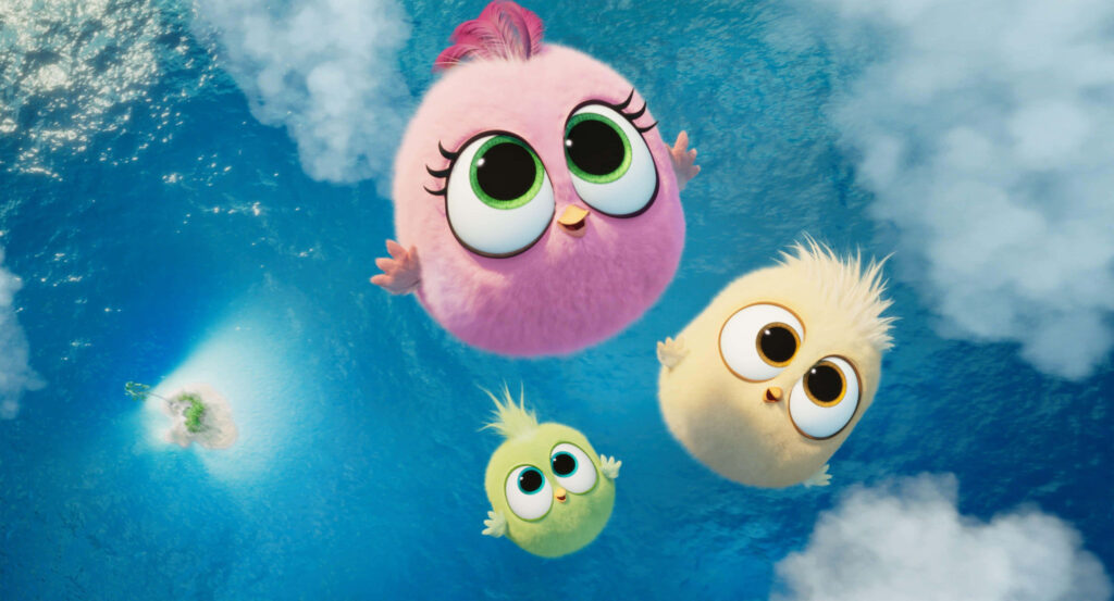 Adorable Angry Birds Hatchlings with big eyes floating above blue ocean and fluffy clouds wallpaper