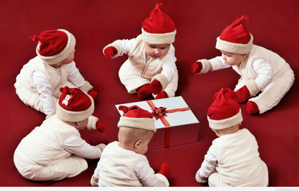 Adorable Babies in Santa Hats Wonder at Gift Box - Festive Wallpaper