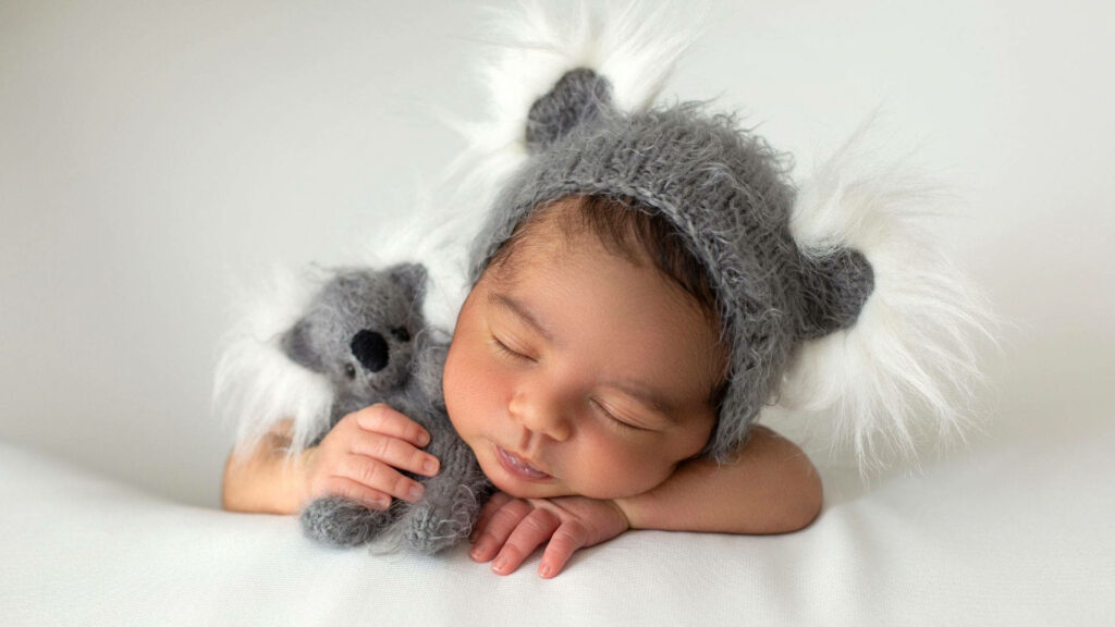 Adorable Baby in Koala Costume - Cozy Nursery Wallpaper