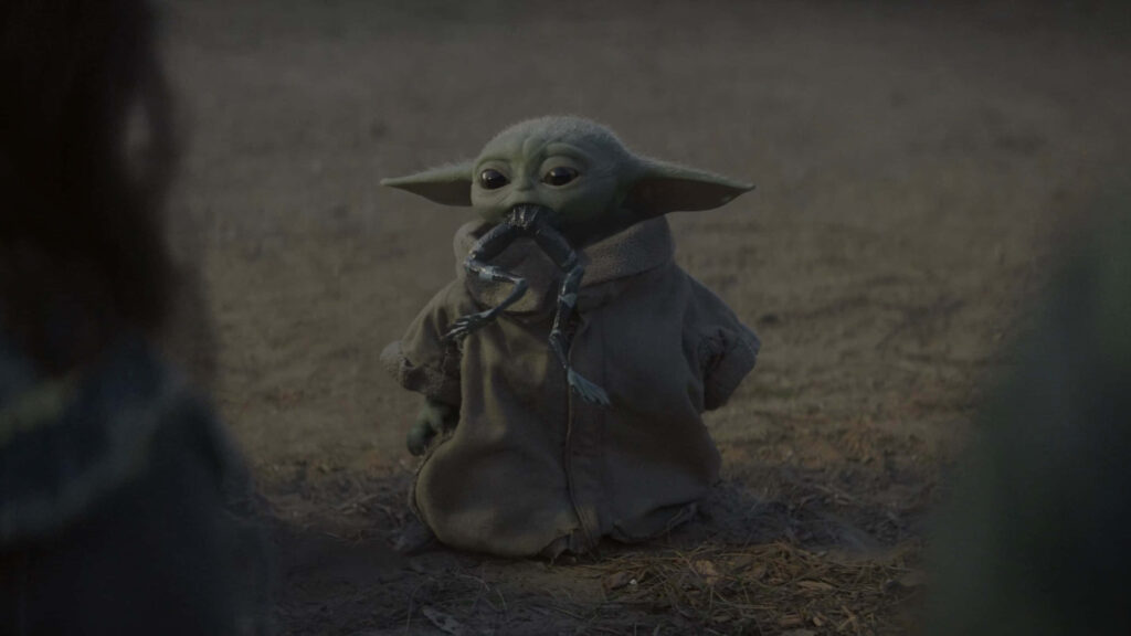 Adorable Baby Yoda Wallpaper: Grogu Munching Frog Legs