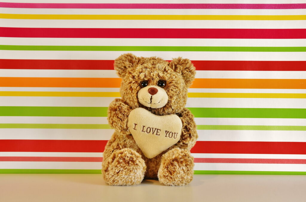 Adorable Brown Bear Embracing a Heart Teddy: Captivating Love in 5K Wallpaper