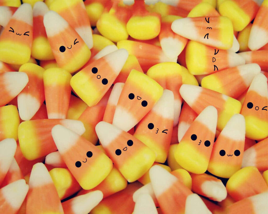 Adorable Candy Corn Wallpaper: Cheerful Cartoon Food Background