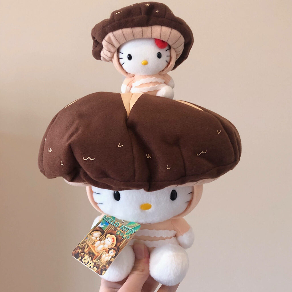 Charming Hello Kitty Plush Toys in Mushroom-Themed Wallpaper Design