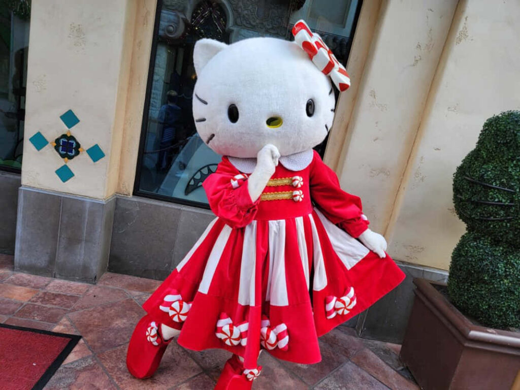 Charming Life-Sized Hello Kitty Wallpaper in Playful Red Dress